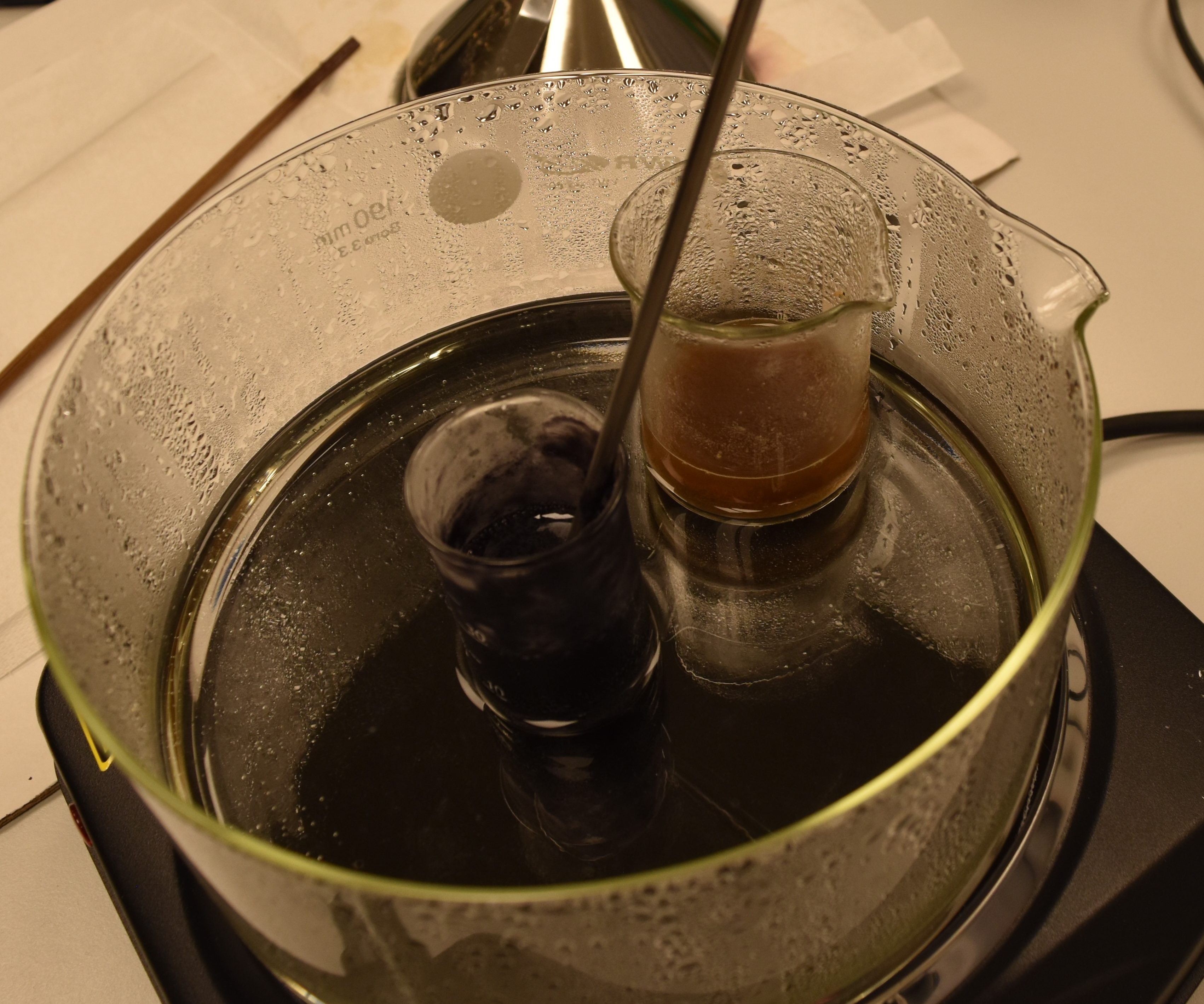 The pitch black of the final iron-gall ink vs. the brown colour of the extract in water before the addition of vitriol. 